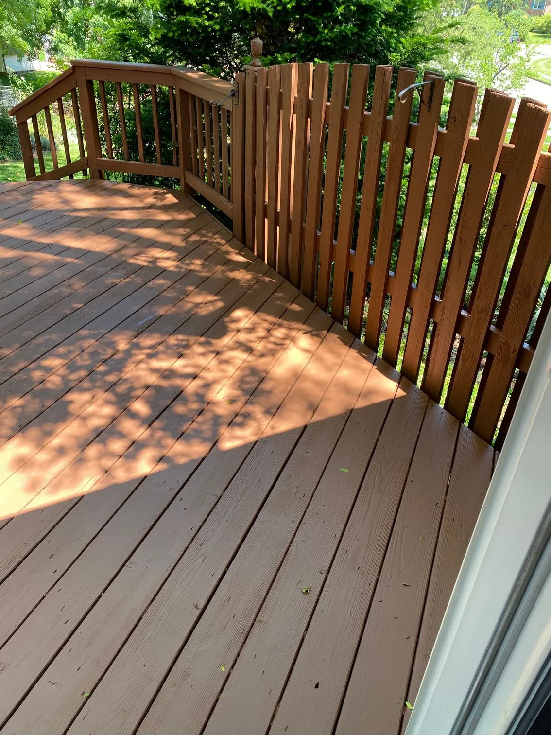 Restained deck with shadow play, semi-transparent finish, strong composition