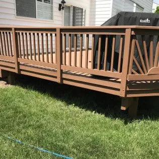 Wider stained deck overlooking green lawn, finished portfolio frame
